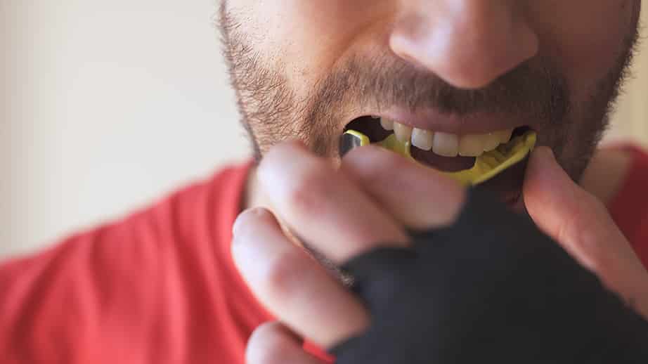 man placing sport mouthguard in franklin tn