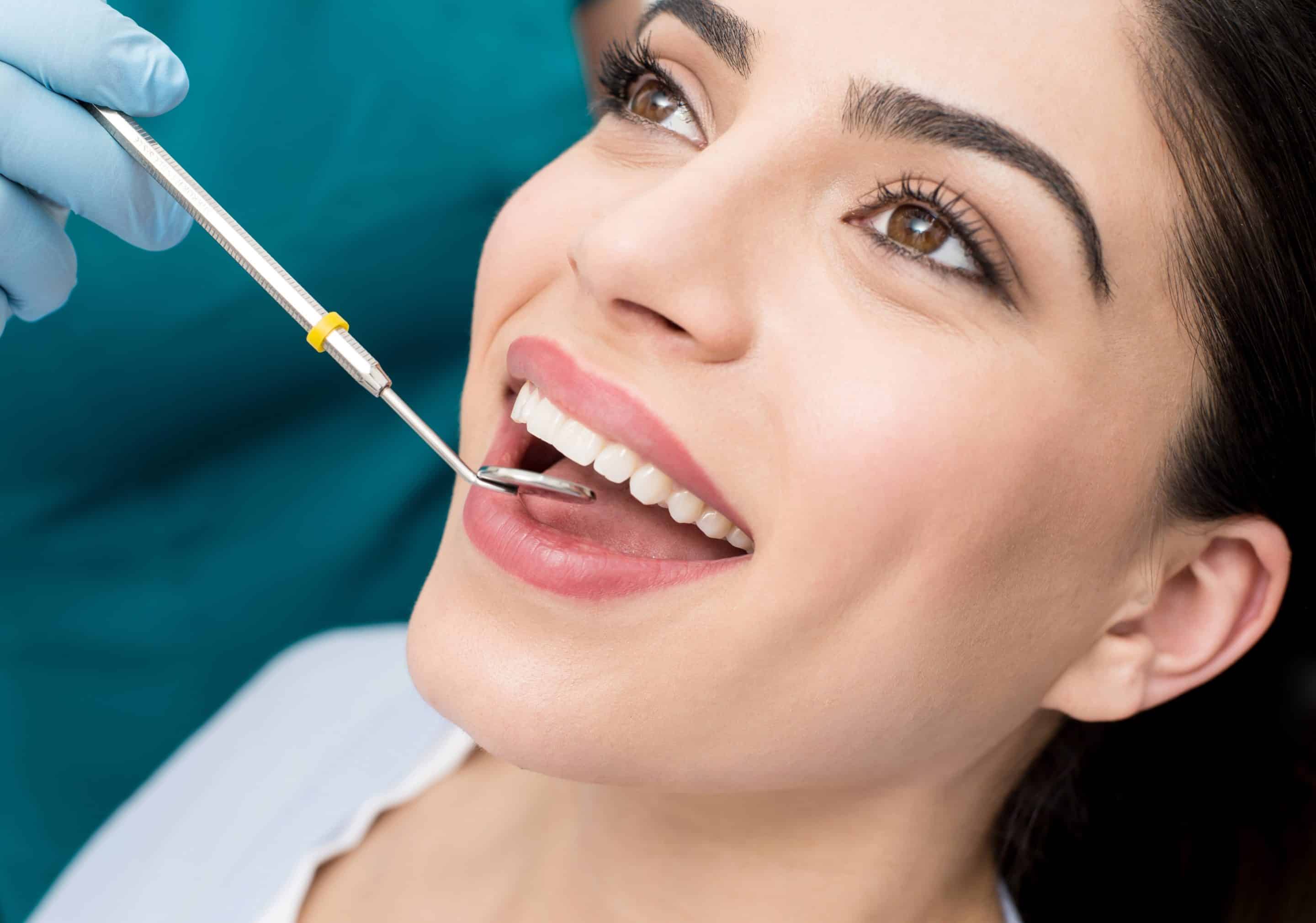 Woman recieves oral exam and dental cleaning in Franklin TX