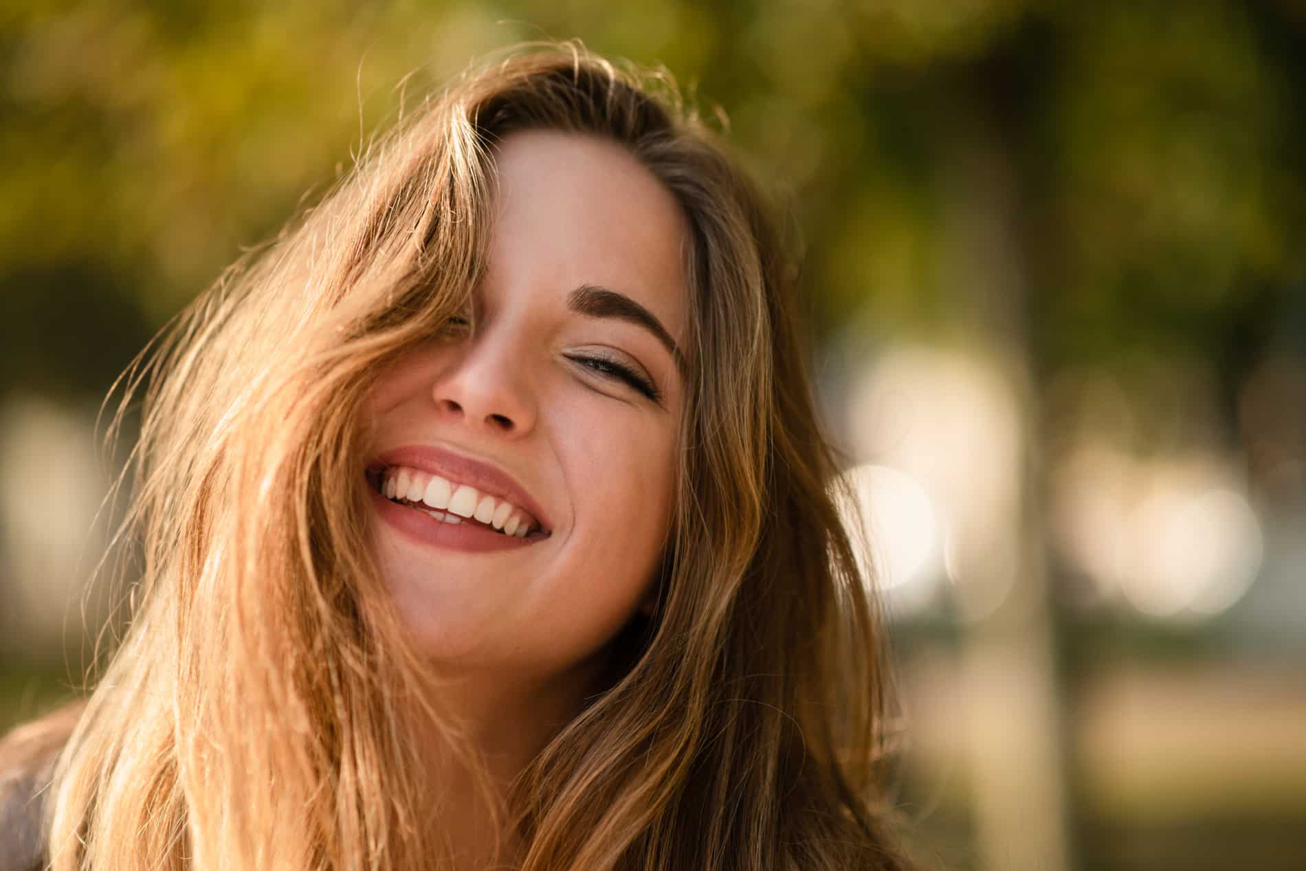 Woman smiling with a new smile after cosmetic dentistry at Longpoint Dental in Franklin TN
