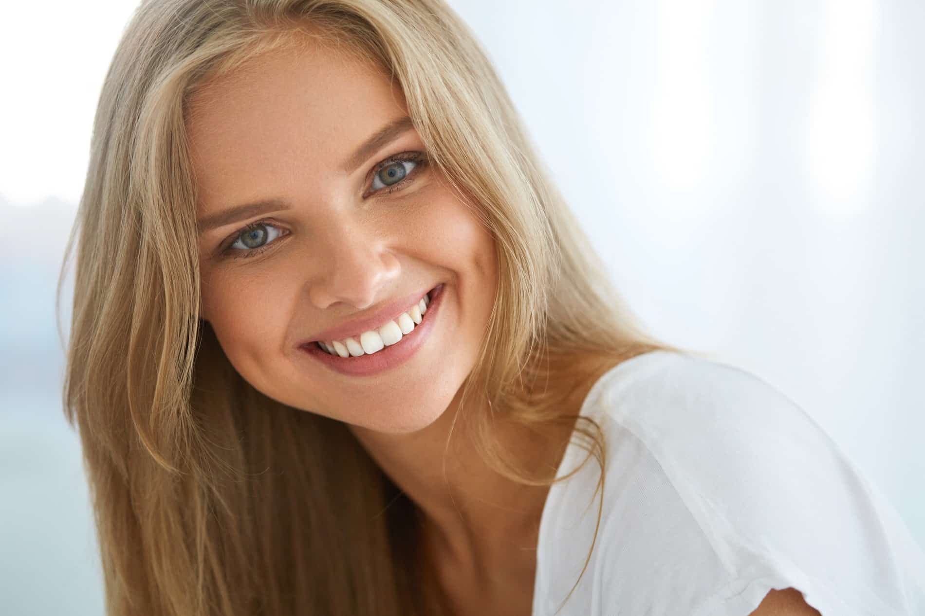 woman smiling with brighter teeth after teeth whitening treatment with Longpoint Dental in Franklin TN